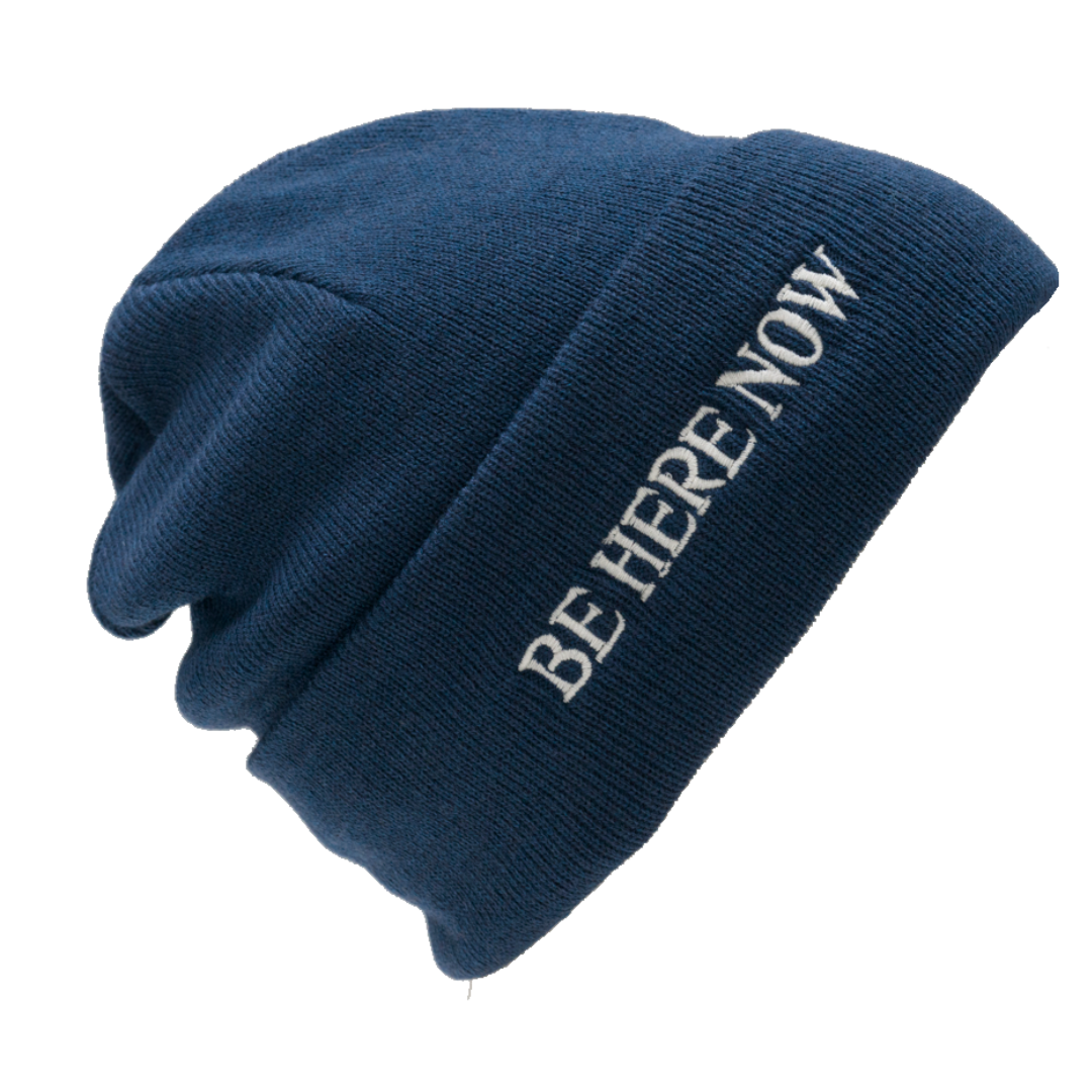 Blue beanie with &#39;BE HERE NOW&#39; text on a white background
