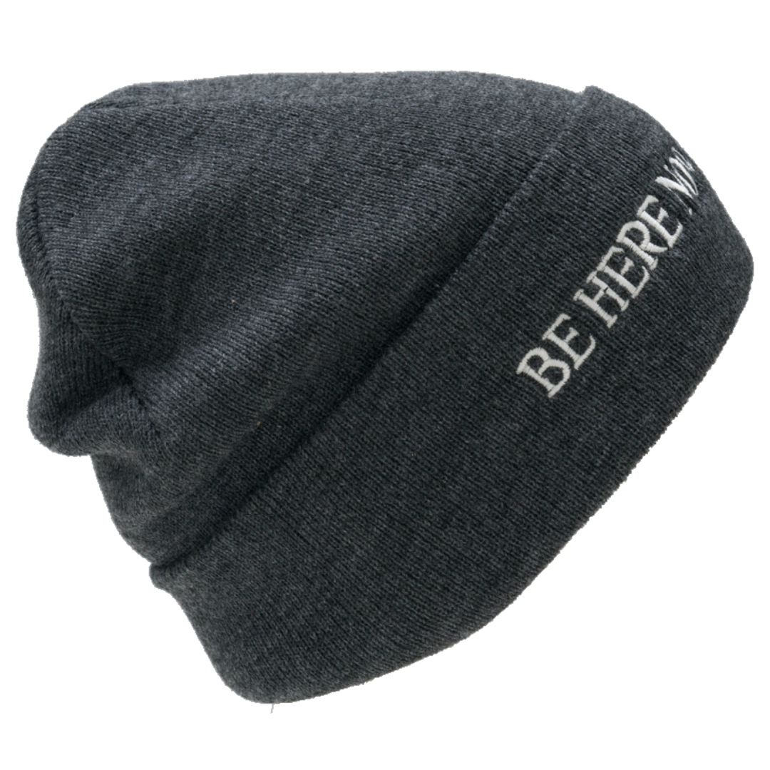 Gray beanie with 'BE HERE NOW' text on a white background