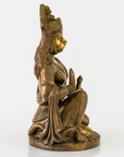 A bronze-finished seated Hanuman statue with gold-painted facial features and highlights, shown in profile against a clean white background.