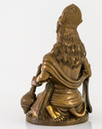 A bronze-colored religious figurine of a kneeling Hanuman, shown from the back, on a plain white background.