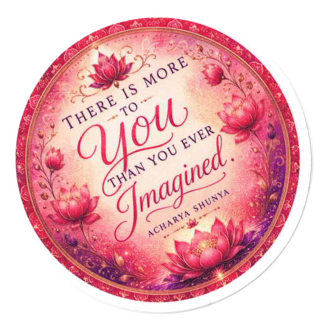 A round sticker or coaster featuring a pink and red lotus floral design with the quote 'THERE IS MORE TO YOU THAN YOU EVER Imagined.' by Acharya Shunya, shown on a white background.