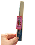 A hand holding a slim, open book or notebook with cream-colored pages and a pink bookmark tag attached. The bookmark tag features a cartoon monkey and the text 'Ram Ram' and 'BookCasts'.