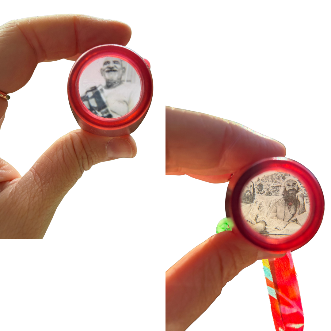Two close-up views of a hand holding a small oval red case or pendant with a printed portrait inside. The left view shows the item alone against a white background, and the right view shows the same item again in the hand with a colorful ribbon attached.