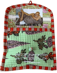 A handmade quilted fabric wall hanging or pocket with a red and cream striped border, a mint green floral patterned lower section, and a top panel featuring a photo of Mahatma Gandhi. A small wooden bead hangs from the bottom center.